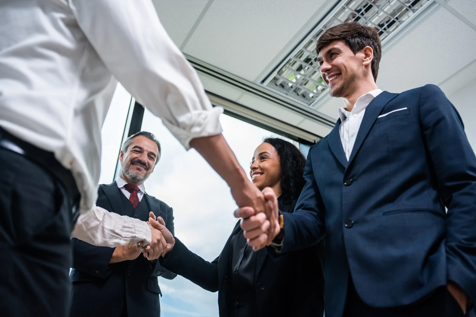 Caucasian businessman making a handshake together while stand in office.